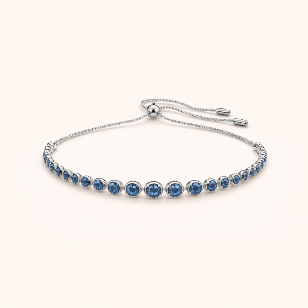 Elegant tennisarmbånd i hvidguld med slebet safir