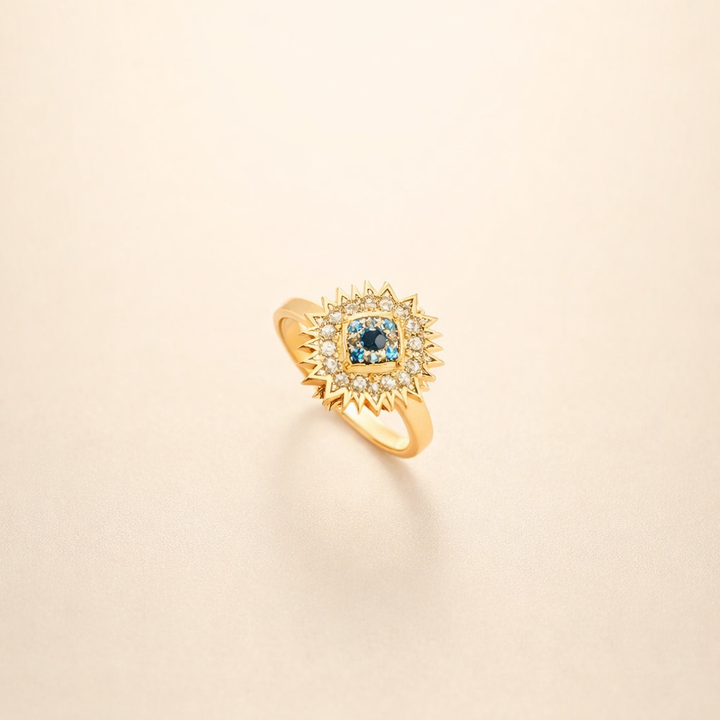 Guld drejering med safir og solstrålesdesign