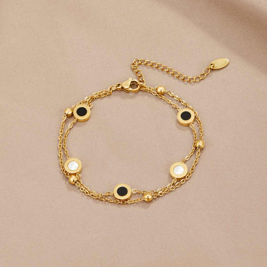 Elegant armbånd med onyx og hvide sten