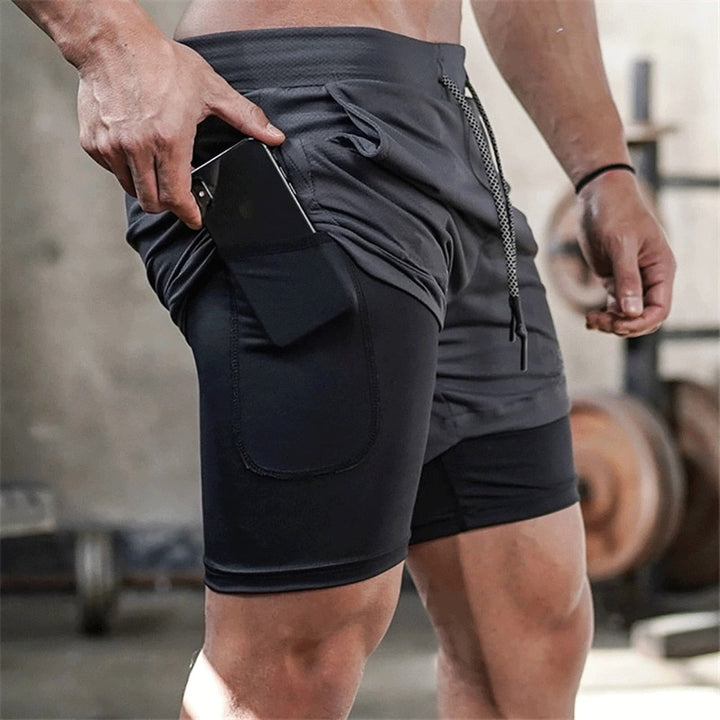 https://cdn.shopify.com/s/files/1/0575/0731/5784/files/m-nds-2-i-1-tr-ningsshorts-med-mobillomme-ideelle--1.jpg?v=1778637513