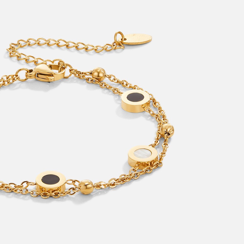 Elegant armbånd med onyx og hvide sten